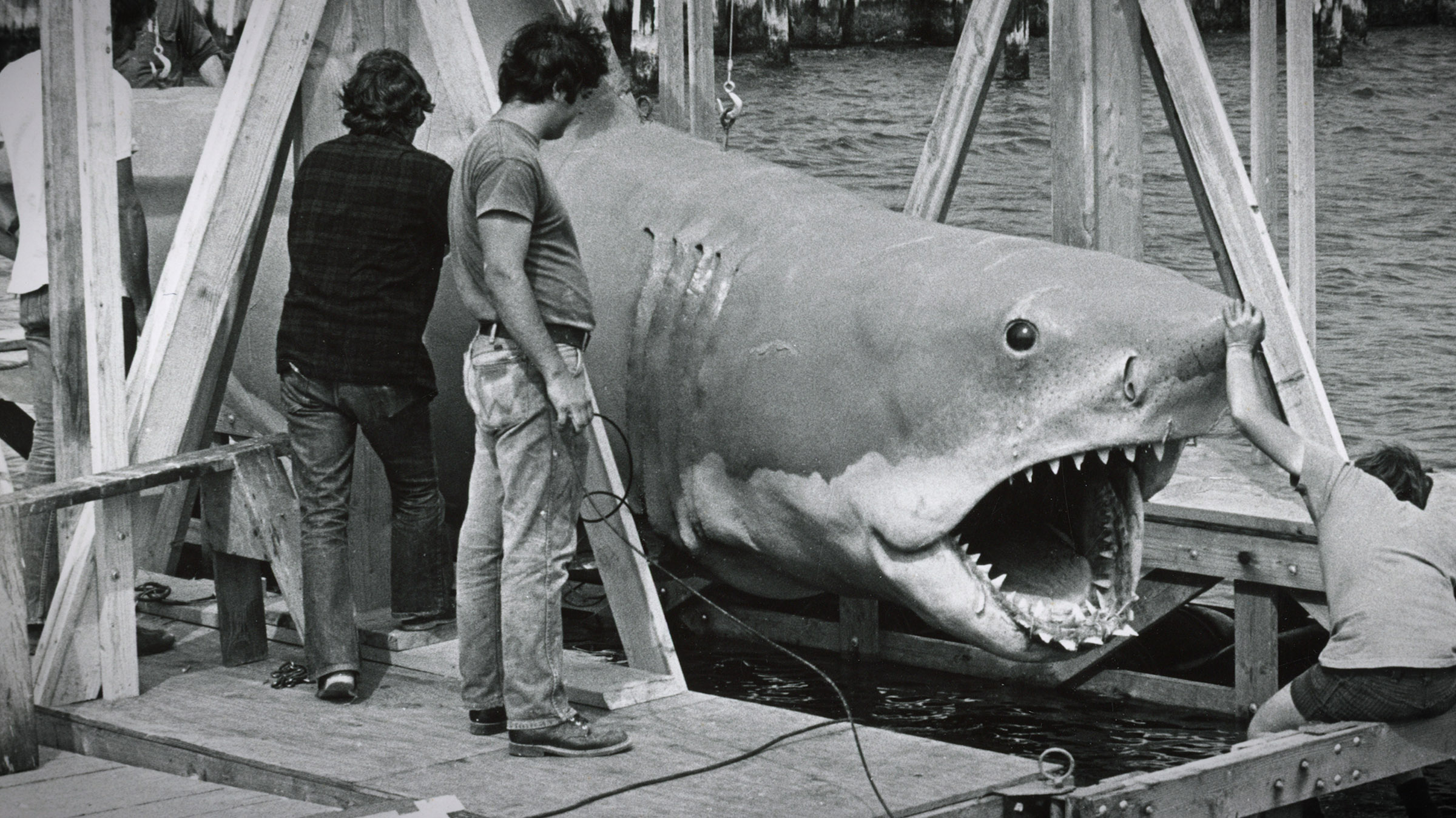 A crew examines the mechanical shark on the set of Jaws. Image from Jaws at 50 The Definitive... [Photo of the day - July 2025]