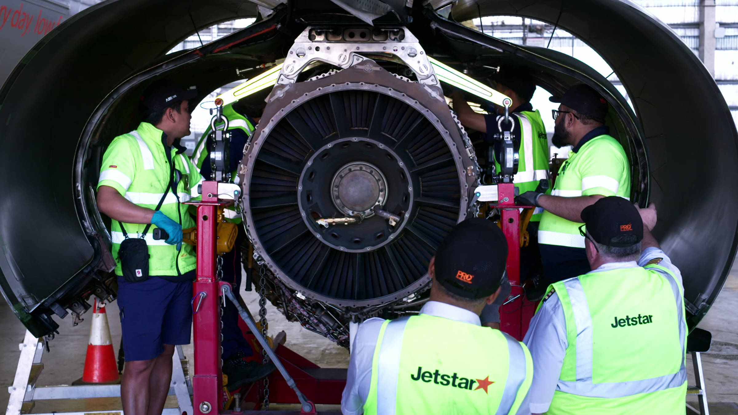Jetstar employees work to hoist a new engine onto a Jetstar plane. [Photo of the day - May 2026]