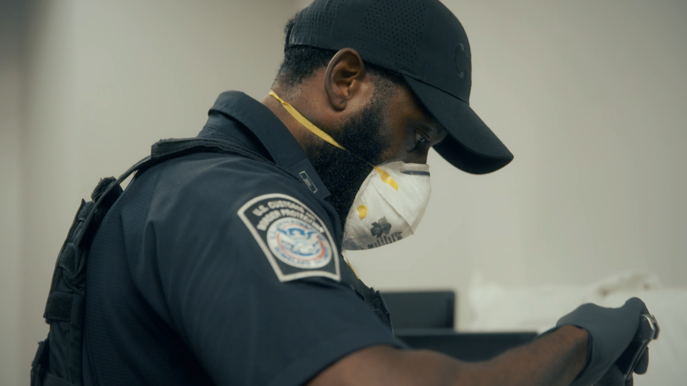 Officer Braddy at Atlanta airport inspecting items found in luggage. [Photo of the day - May 2026]
