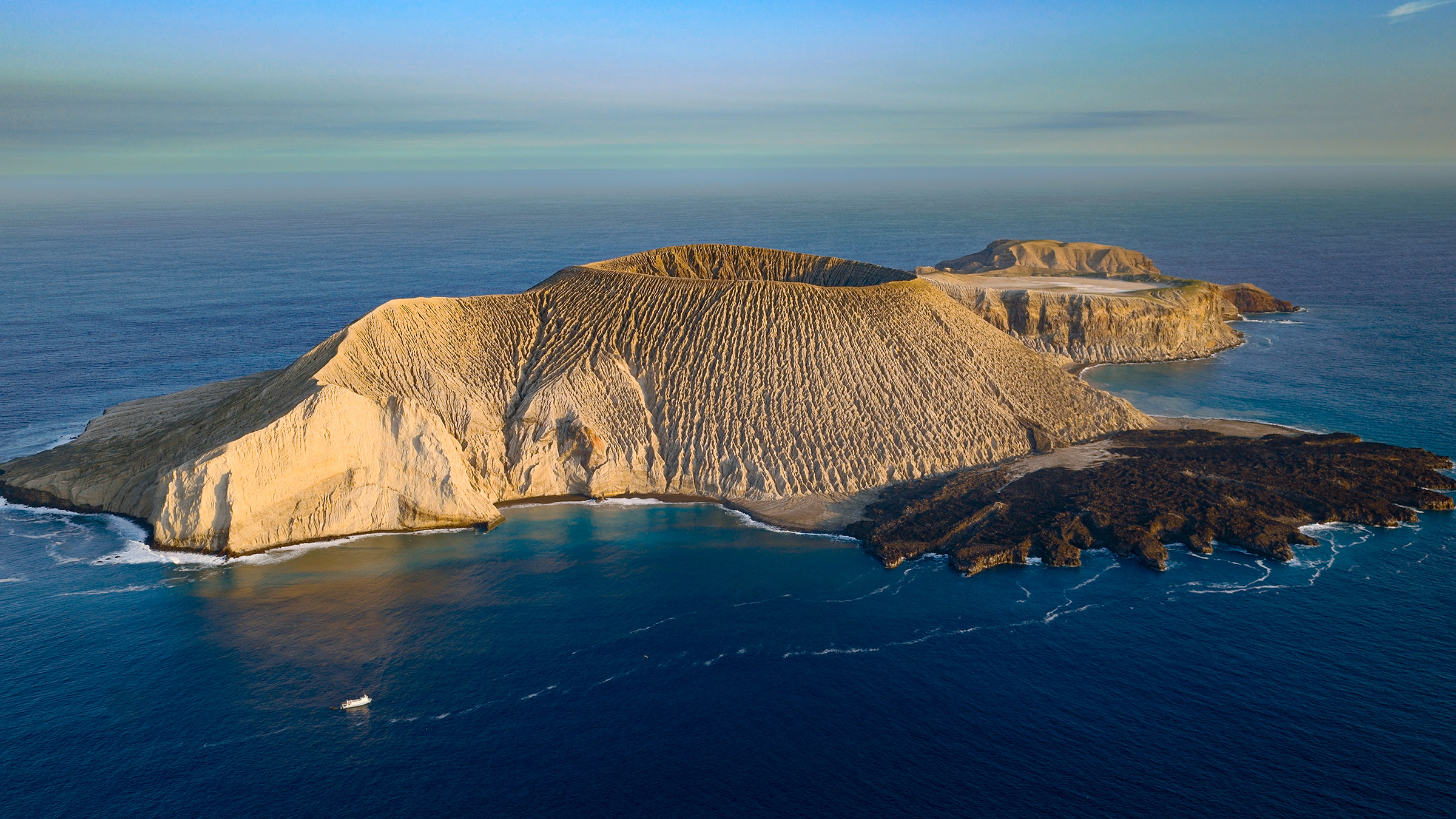 Active volcanic island, San Benedicto. Image from Hammerhead Sharks Up Close with Bertie Gregory. [Photo of the day - July 2026]